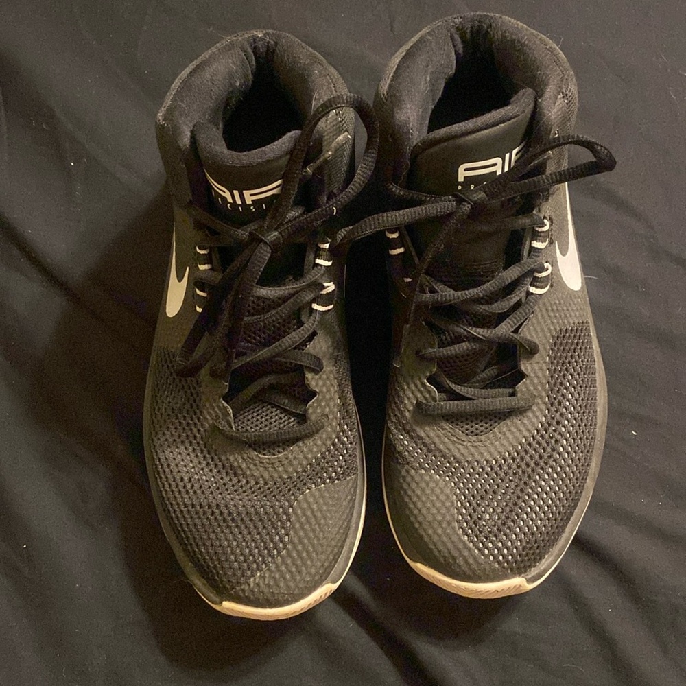 Black and white NIKE Air Precision Court shoes.